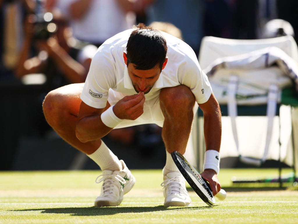 Novak Djokovic tests the grass at Wimbledon