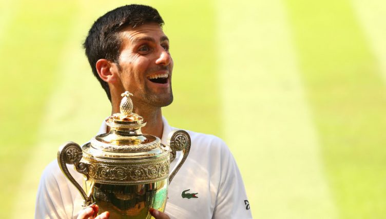 Novak Djokovic celebrates with Wimbledon trophy