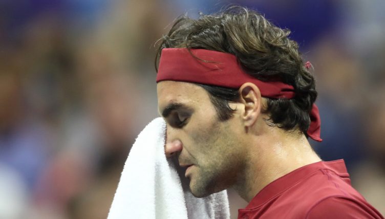 Roger Federer wiping his face