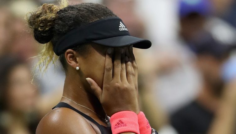 Naomi Osaka covers her face