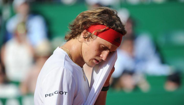 Alexander Zverev wiping his face