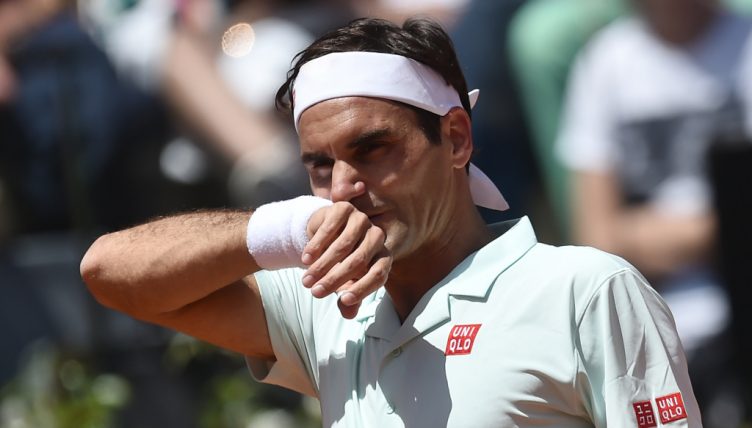 Roger Federer wiping his face