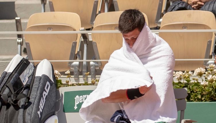 Novak Djokovic wrapped in a towel