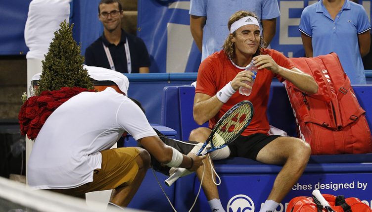 Nick Kyrgios kneeling to Stefanos Tsitsipas