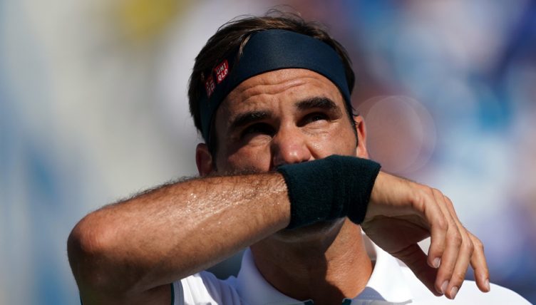 Roger Federer wiping his face