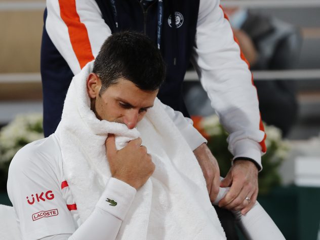 Novak Djokovic receives medical assistance during his victory over Pablo Carreno Busta