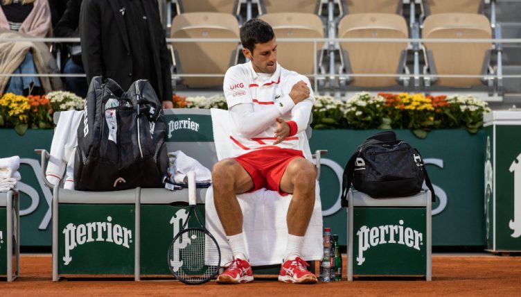 Novak Djokovic feeling his shoulder