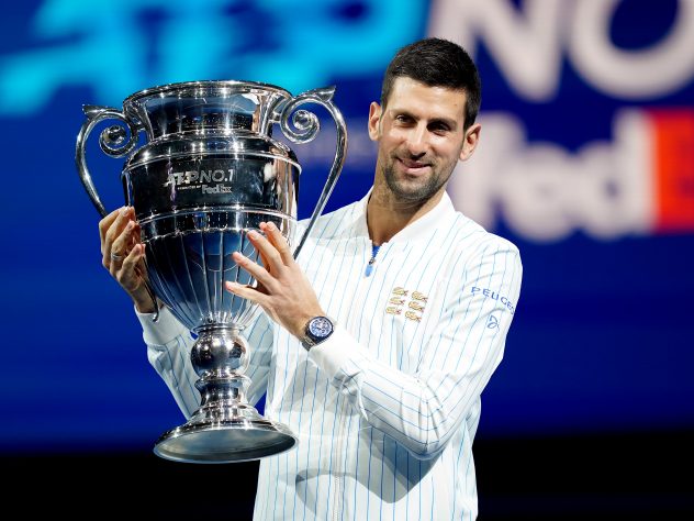 Novak Djokovic poses with his year-end ATP number one trophy