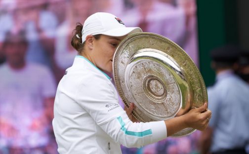 Ashleigh Barty has a closer look at the Wimbledon trophy