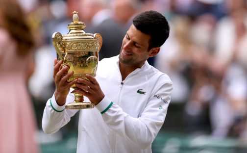 Novak Djokovic admires the Wimbledon trophy