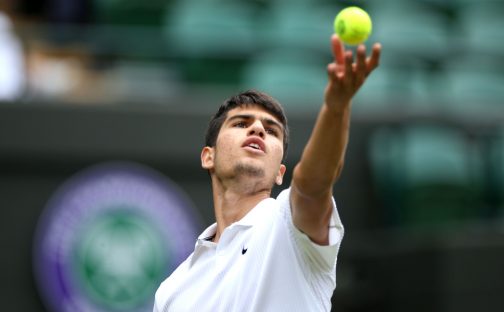 Carlos Alcaraz tosses the ball