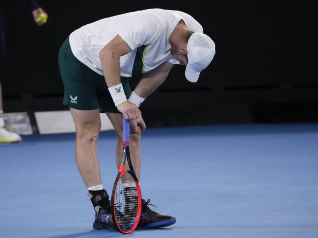 Andy Murray leans on his racket 