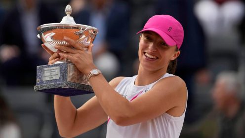 Iga Swiatek, of Poland, holds her trophy after defeating Aryna Sabalenka, of Belarus, in the Italian Open tennis tournament final match at Rome's Foro Italico, Saturday, May 18, 2024. Swiatek won 6-2/6-3