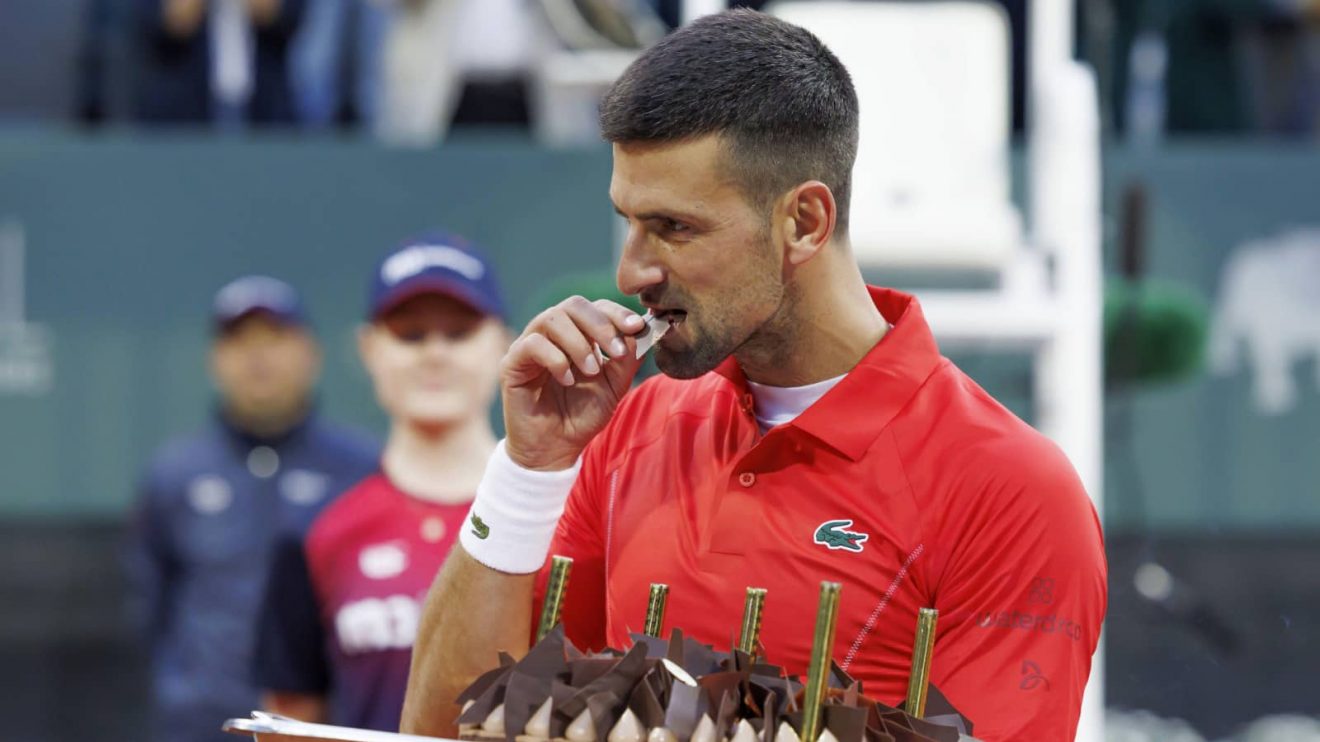 Serbia's Novak Djokovic tastes his birthday cake after he won his second round match of the ATP 250 Geneva Open tennis tournament against Germany's Yannick Hanfmann in Geneva, Switzerland, Wednesday, May 22, 2024