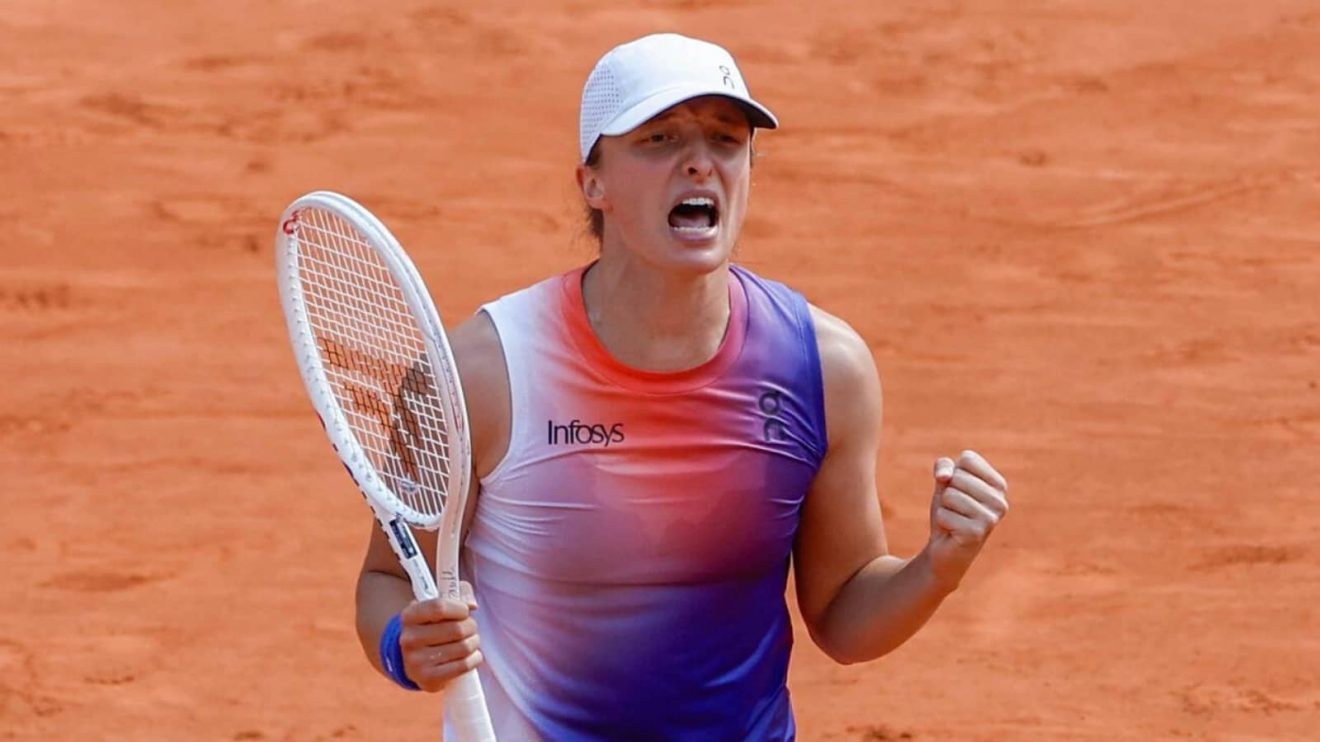 Poland's Iga Swiatek celebrates winning her semifinal match of the French Open tennis tournament against Coco Gauff of the U.S. at the Roland Garros stadium in Paris