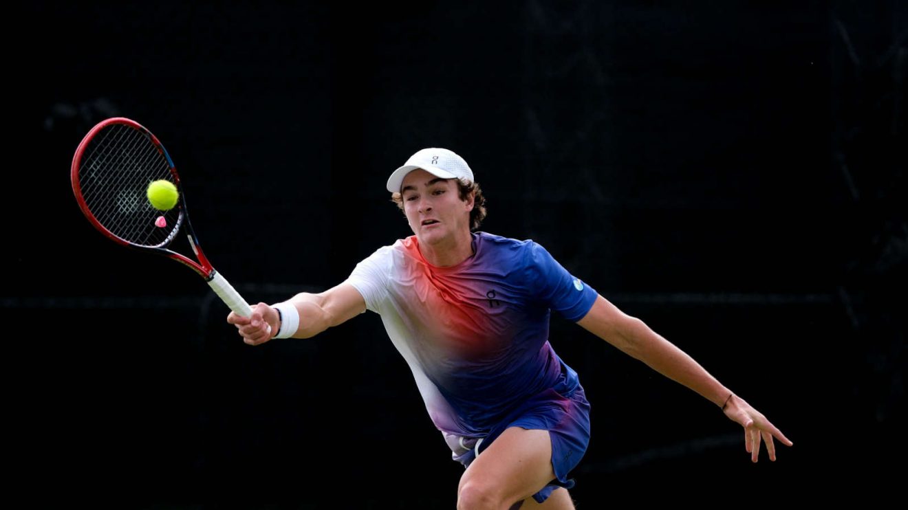 Joao Fonseca stretches to reach a forehand