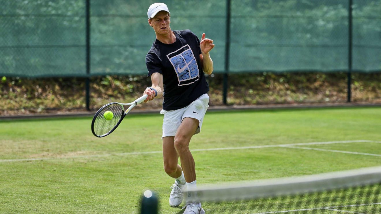 Jannik Sinner practises on a grass court