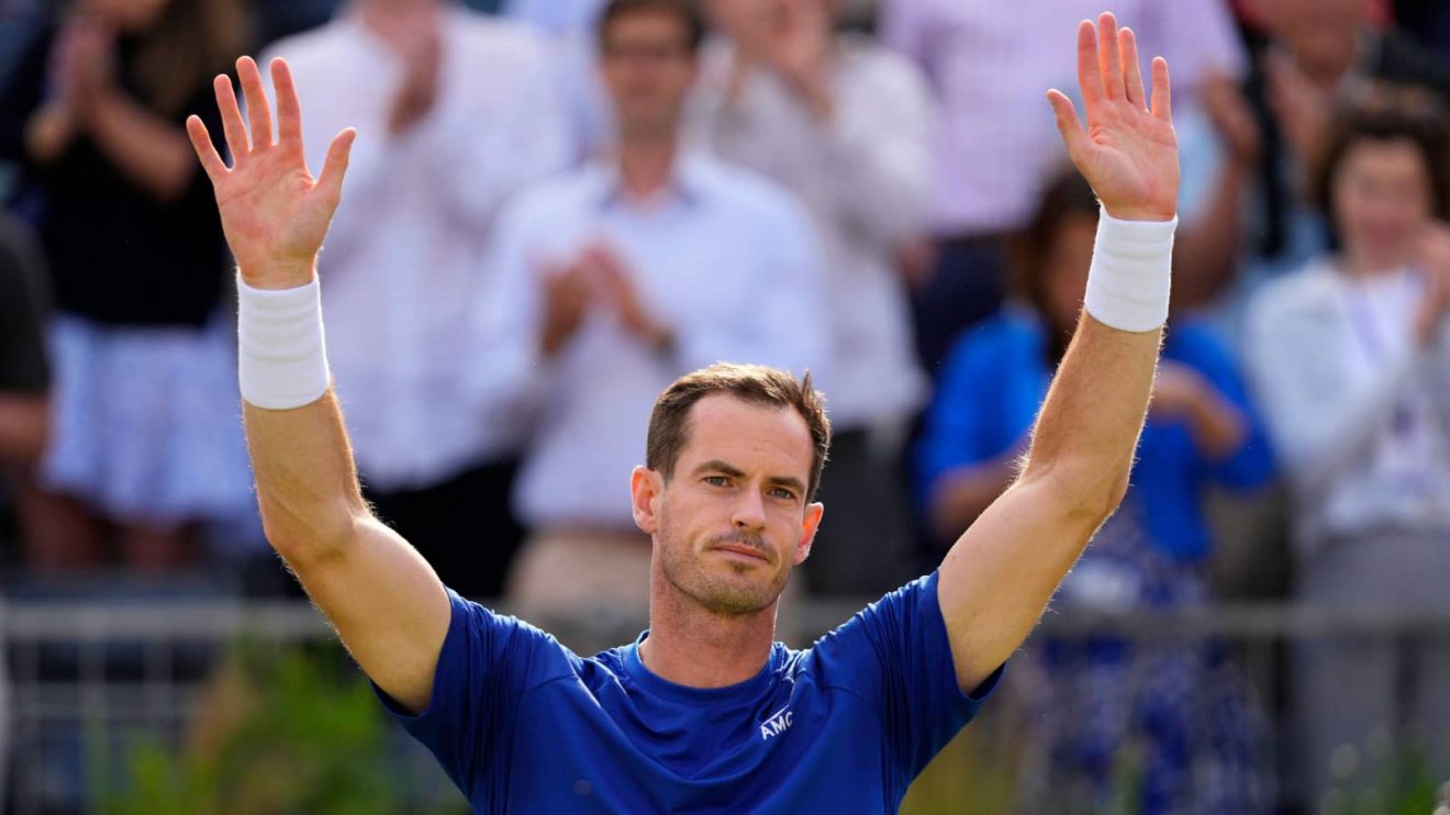 Andy Murray of Britain holds up his hands to applause from the crowd as he retires due to injury from his match against Jordan Thompson of Australia during their men's singles match on day five of The Queen's Club tennis tournament, in London