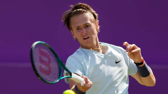 Sebastian Korda of the US plays a return to Grigor Dimitrov of Bulgaria during their men's singles match on day five of The Queen's Club tennis tournament, in London