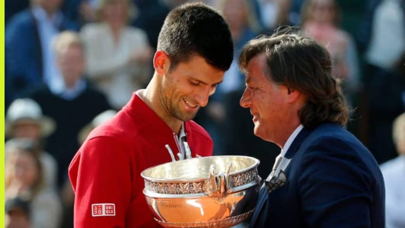 Adriano Panatta hands the 2016 French Open trophy to Novak Djokovic