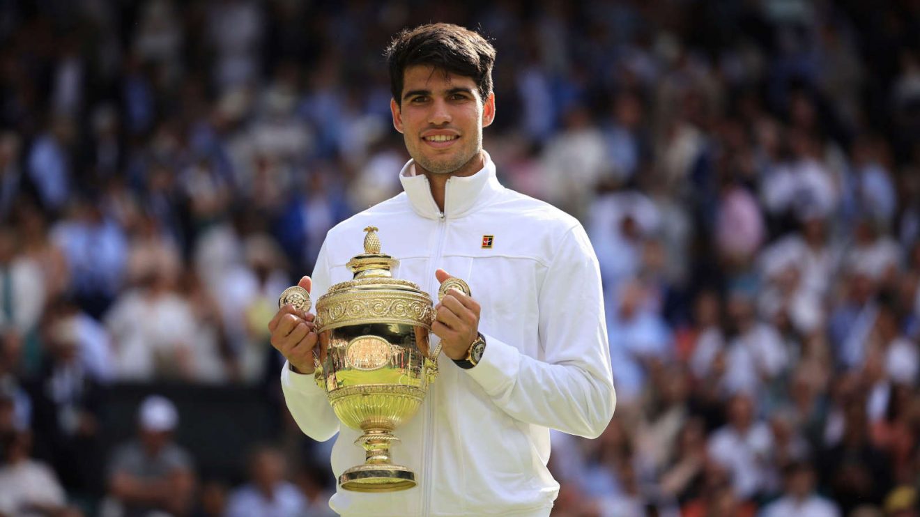 Carlos Alcaraz lifts the Wimbledon trophy