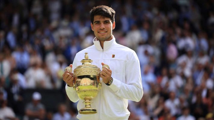 Carlos Alcaraz lifts the Wimbledon trophy