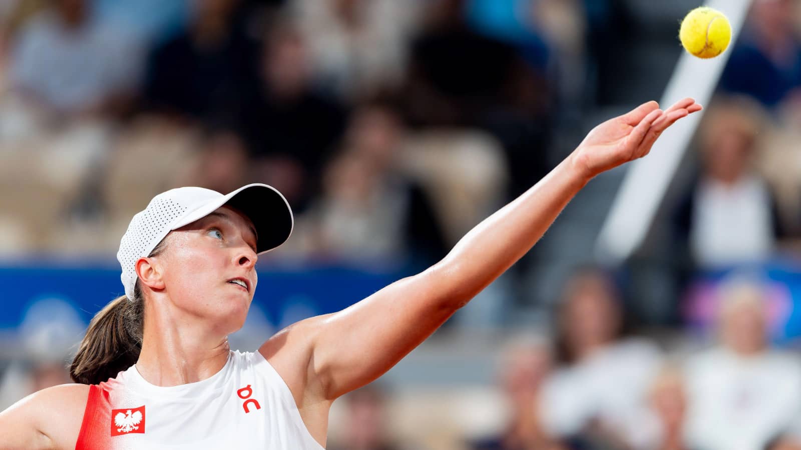 Iga Swiatek serves at the 2024 Paris Olympics