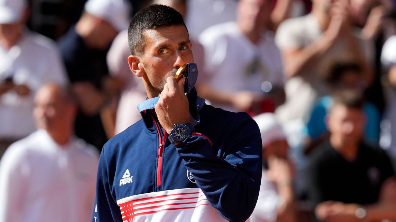 Novak Djokovic kisses his gold medal at the 2024 Paris Games