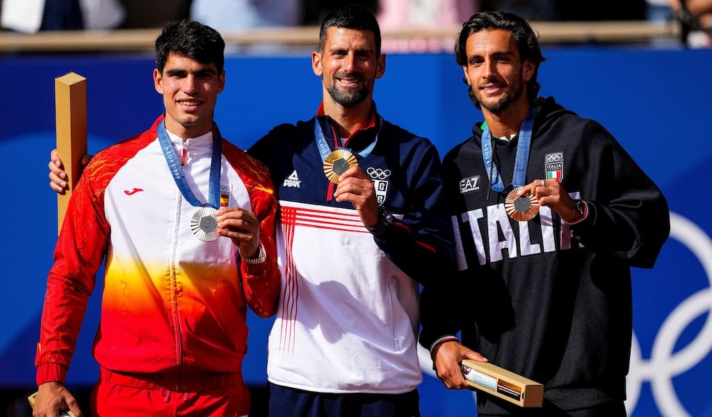 Novak Djokovic, Carlos Alcaraz, and Lorenzo Musetti on the Paris 2024 podium.