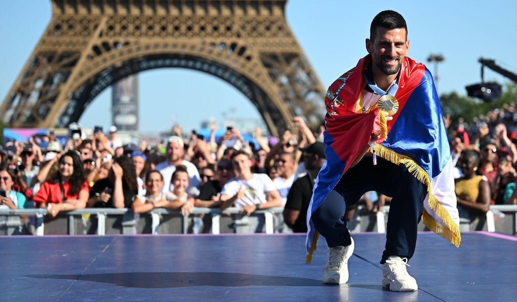 (Pictured) Novak Djokovic with his Olympic gold medal, in front of the Eiffel Tower.