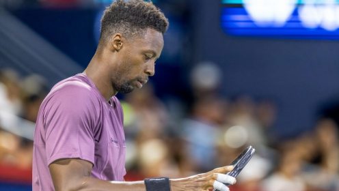 Gael Monfils looks down at his racket during a loss at the Canadian Open