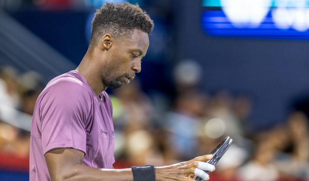 Gael Monfils looks down at his racket during a loss at the Canadian Open