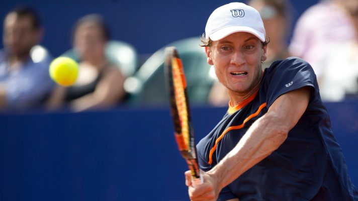 Renzo Olivo of Argentina returns the ball