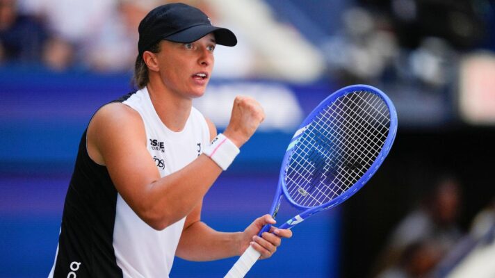 Pictured: Iga Swiatek fistpumps during a match.
