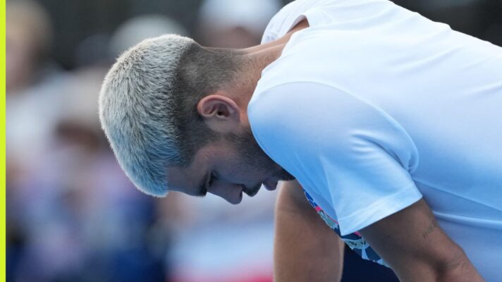 Carlos Alcaraz looks down