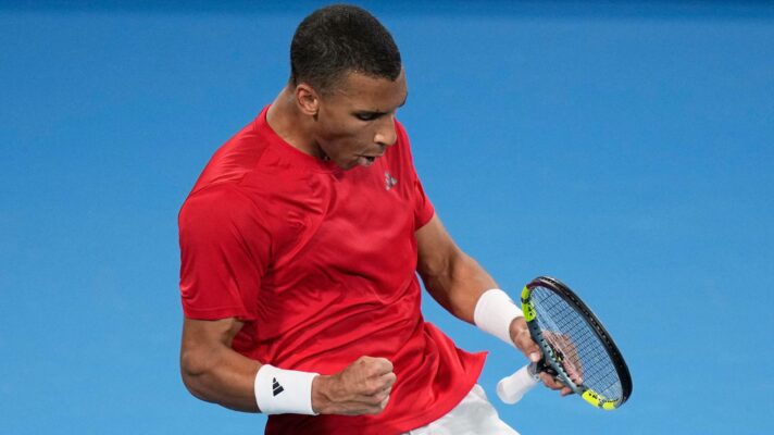 Pictured: Felix Auger-Aliassime celebrates during a match.