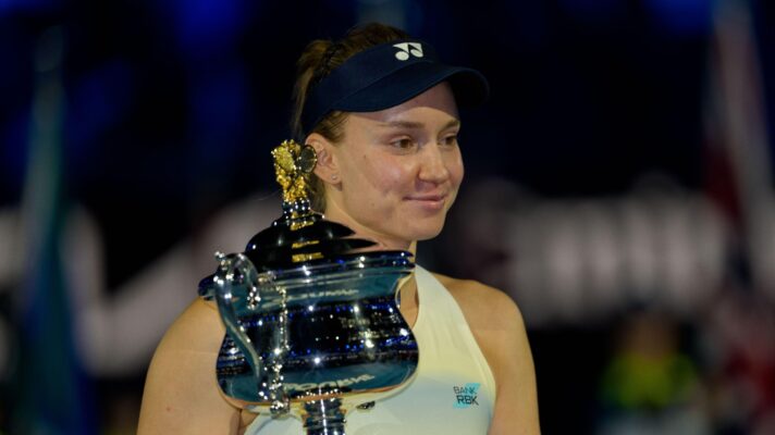 Pictured: Elena Rybakina smiles while holding the Australian Open trophy.