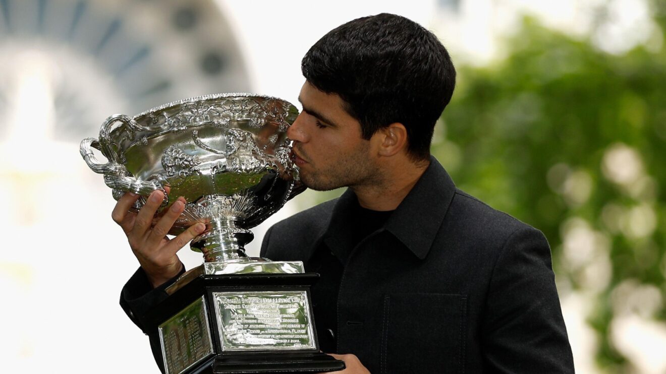 Carlos Alcaraz kisses the Australian Open trophy