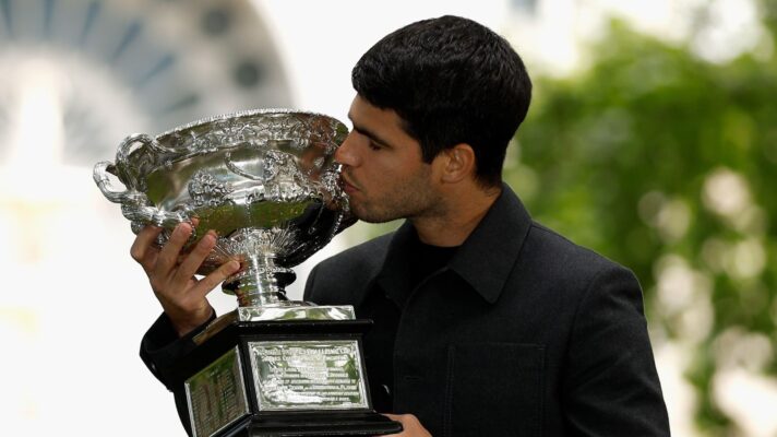 Carlos Alcaraz kisses the Australian Open trophy