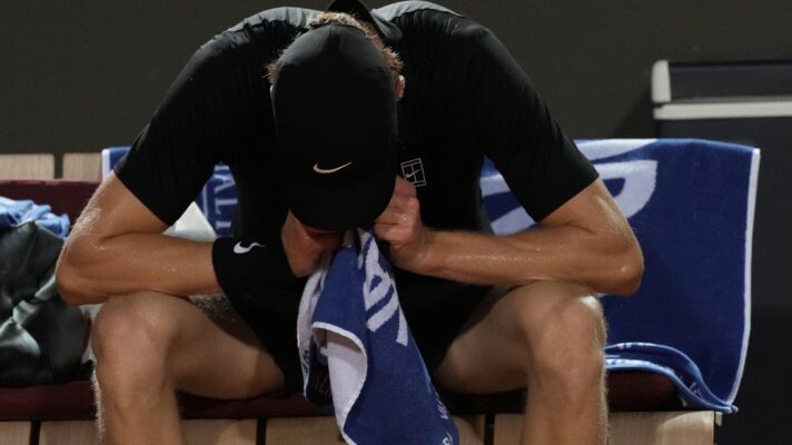 Jannik Sinner with his head in his hands at the Italian Open