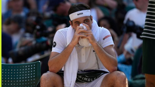 Pictured: Taylor Fritz puts his head in his hands at Wimbledon