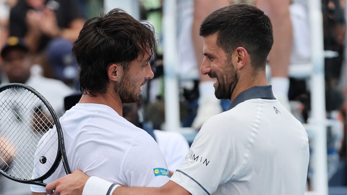 Thiago Tirante Agustin and Novak Djokovic embracing at the net at the Cincinnati Open