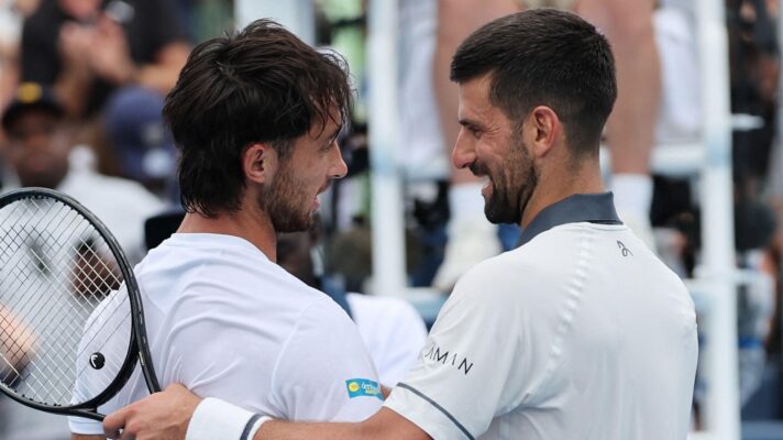 Thiago Tirante Agustin and Novak Djokovic embracing at the net at the Cincinnati Open