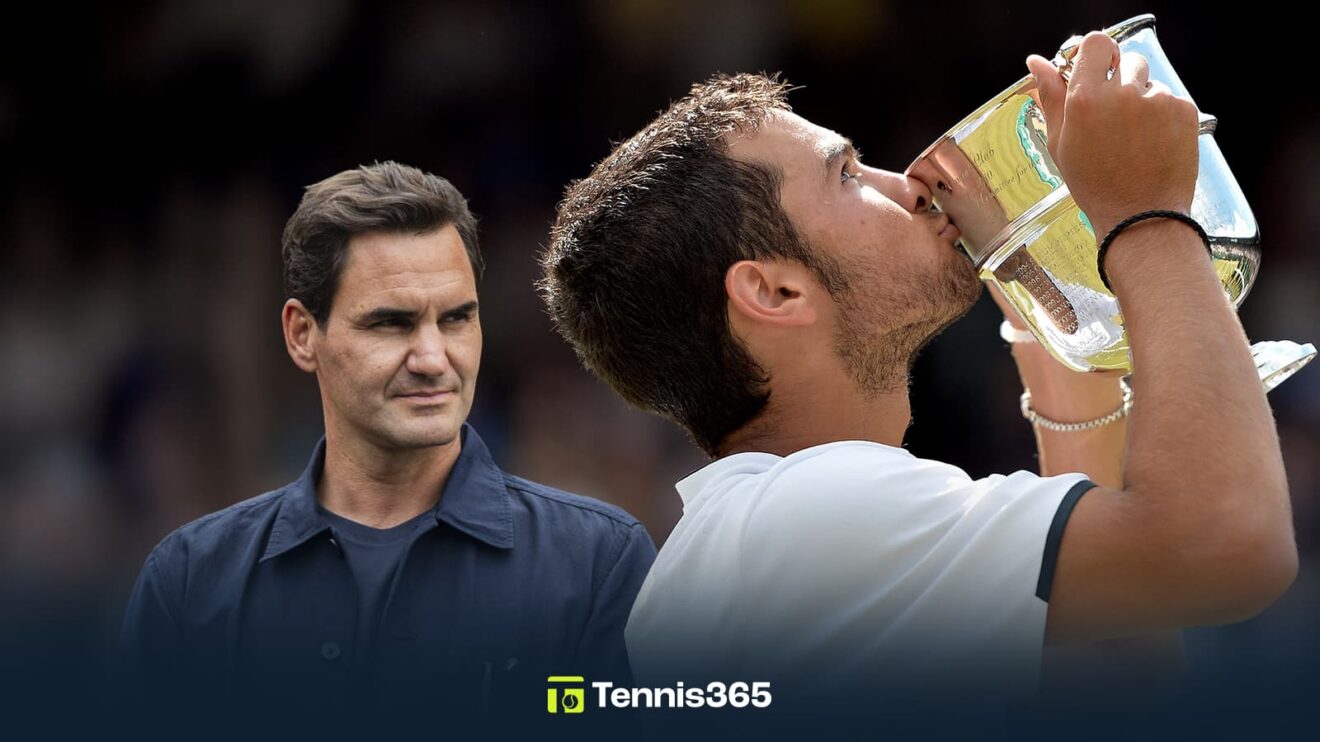 Pictured: Noah Rubin kisses his Wimbledon Boys' trophy, with Roger Federer in the background