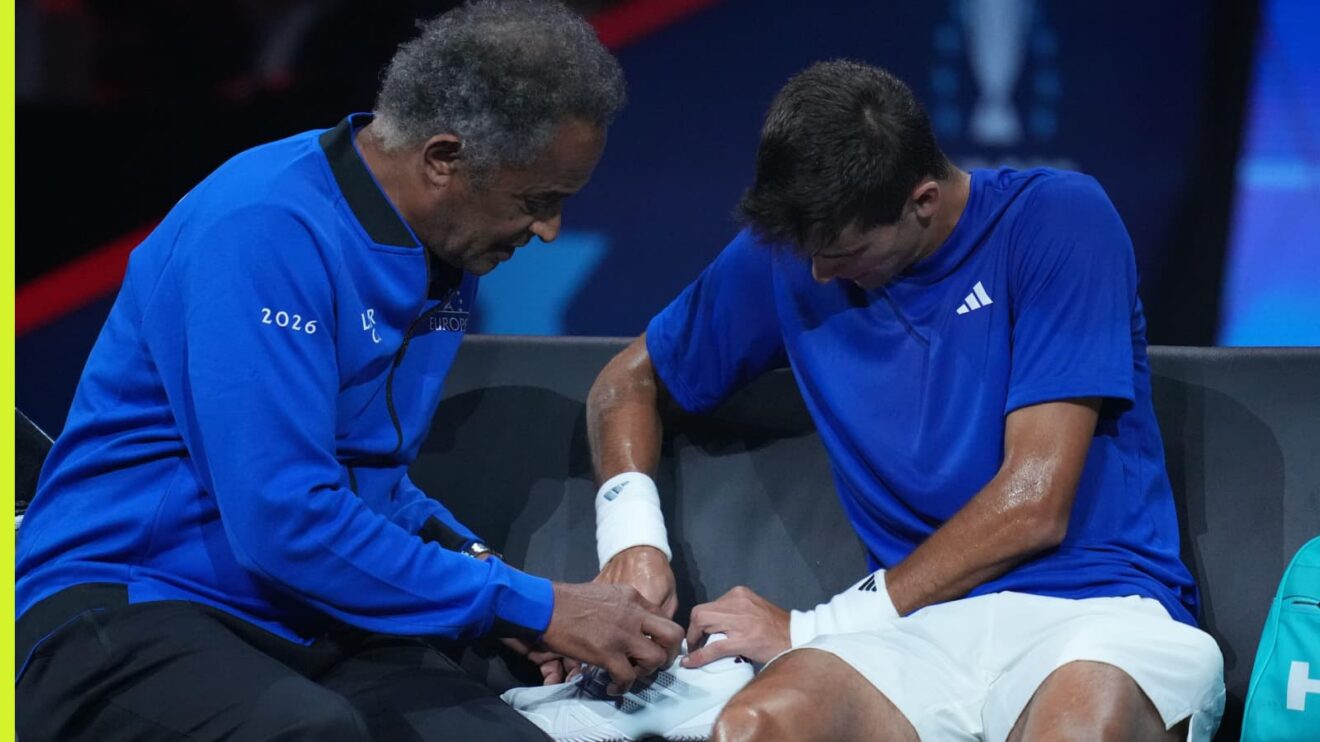 Pictured: Yannick Noah and Rafael Jodar try to fix the Spaniard's shoelaces at Laver Cup