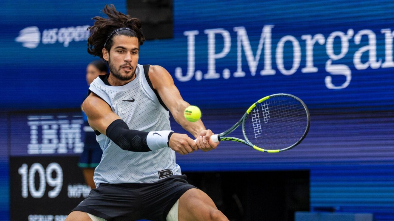 Carlos Alcaraz hitting a backhand against Tommy Paul at the 2026 US Open.