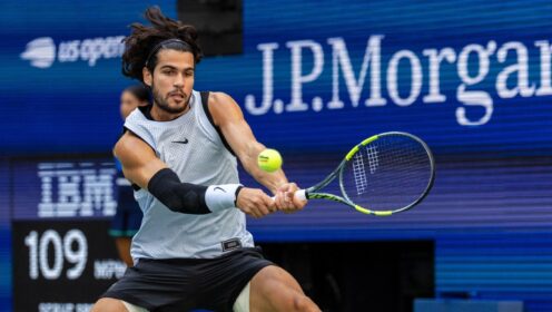 Carlos Alcaraz hitting a backhand against Tommy Paul at the 2026 US Open.